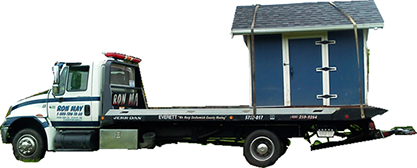 Ron May Towing flatbed truck towing/transporting a shed