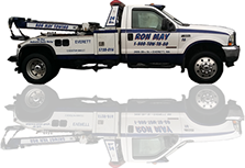 A white Ron May Towing tow truck with a reflection